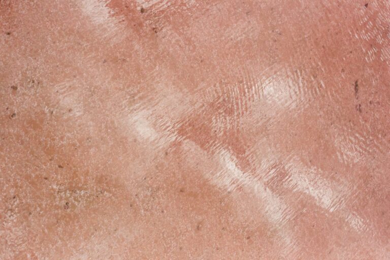 Textured pink surface with a reflective shine.