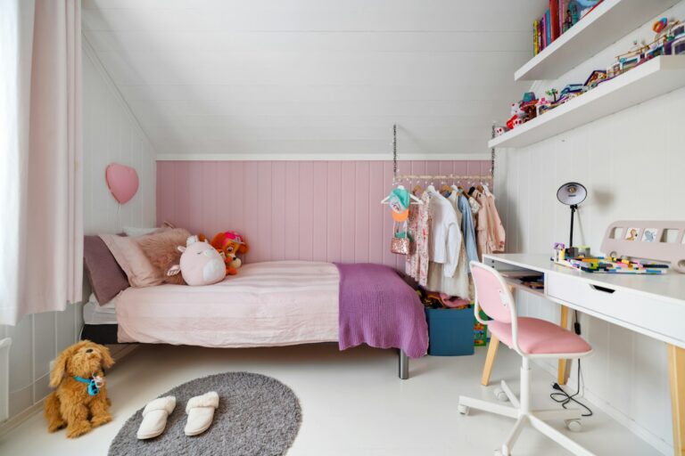 A child's bedroom with a bed, desk, and chair